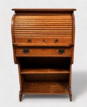 An early 20th century oak roll-top bureau of narrow proportions, with retracting scribe, roll-top