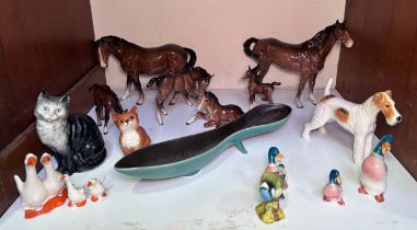 A collection of Beswick horses and foals, birds, cats and dogs, together with a Beswick 'Colin