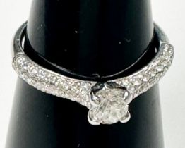 An 18ct white gold 'Canadian Ice' diamond ring, claw set with a round brilliant cut diamond to the