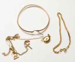 A 9ct yellow gold bangle, a 9ct gold rope-link bracelet, a 9ct gold cross and chain, a 9ct gold '