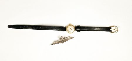 A lady’s 9ct gold cocktail watch on leather strap and a silver RAF sweetheart brooch.