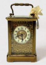 An early 20th century brass carriage clock, the white chapter wheel with Arabic numerals denoting