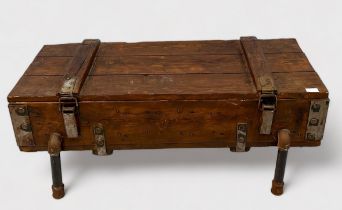 A stained pine ammunition box with mounted metal fixings, converted into a low coffee table,