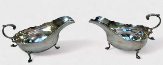 A pair of Edwardian silver sauce boats by Robert Stebbings, of typical oval bellied form and