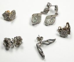 Five assorted pairs of silver earrings, all set with diamonds, total weight 14.3 grams.