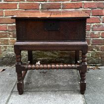 A late 17th/ early 18th century stained oak bible box on stand with lozenge carved front and