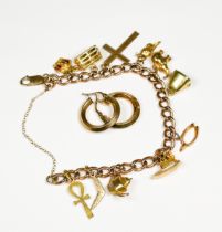 A ladies 9ct gold charm bracelet, with 11 x various charms, including elephant, teapot and cross