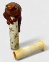 A Japanese Meiji period (1868-1912) carved boxwood and bone cylindrical scroll holder, the tube