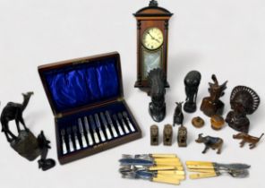 A collection of assorted ethnic carved figures and animals, together with a cased set of silver-