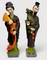 A pair of large polychrome-painted reconstituted stone figures of a Japanese man and woman in