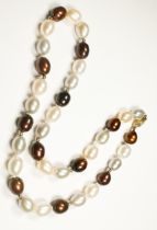 A single row of bronze and cream freshwater pearls, knotted with 10 x small gold beads and a 14ct