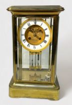 A four-glass brass mantel clock, by J.W. Benson Ltd, with 8-day spring-driven movement striking a