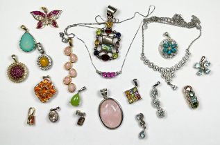 Twenty assorted silver pendants, set with various coloured gemstones, including blue topaz and