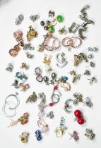 Fifty pairs of assorted earrings, set with diamonds and other various coloured gemstones,
