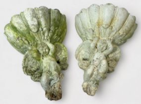 A pair of reconstituted stone garden wall pockets, moulded as cherubs, 28x23cm