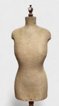 A vintage female torso mannequin on beechwood tripod stand