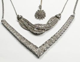 Three various silver diamond set pendants, total estimated diamond weight 1.25cts, total weight 21.0