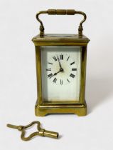 A French brass cased carriage clock, the white enamel dial with Roman numerals denoting hours,