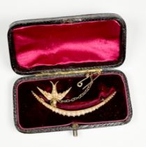 An unmarked Edwardian gold and seed pearl brooch, of crescent form, set with graduated blister