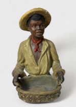 A 1920s painted ceramic figure of an Afro-American cotton-picker in the style of artist William