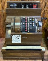 A National Cash register, pre-decimal, with mahogany wood effect finish to the metal case,