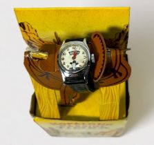 A mid-20th century Hopalong Cassidy Timex wristwatch, the white dial with Arabic numerals denoting