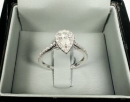An 18ct white gold ring, claw set to the centre with a pear shaped diamond, colour G, clarity VS2,