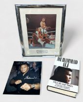 A small collection of assorted signed Muhammad Ali items including a book, ‘His Life and Times’, a