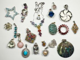 Twenty assorted silver pendants, set with various coloured gemstones including blue topaz, and white