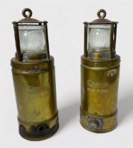 A pair of brass 'Oldham' miner's safety lamps, 27cm high
