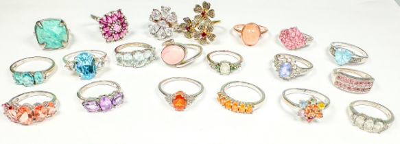 Twenty various silver dress rings, set with diamonds and coloured stones, total weight 75.0 grams.
