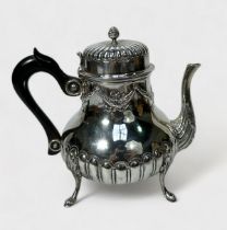 A silver teapot by C. S. Harris & Sons Ltd, with relief moulded reeded decoration and swags,