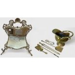 A collection of fireside brassware including a mirrored rococo firescreen, brass fender, coal