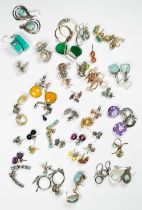Thirty-five pairs of silver earrings, set with diamonds and various coloured gemstones, including