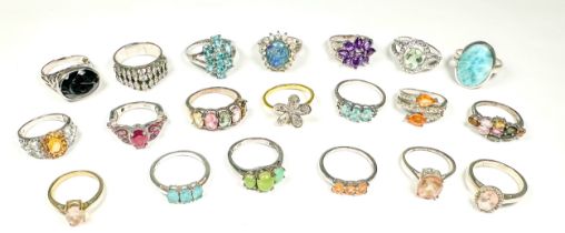 Twenty various silver rings set with diamonds and coloured gemstones, including blue topaz and