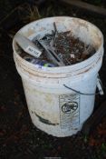 A large bucket of assorted nails and screws.