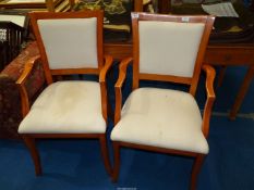 A pair of cream upholstered Armchairs.