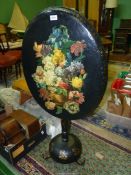 An attractive papier mache oval topped Snap-top Occasional Table standing on a turned support,