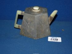 A Chinese engraved pewter teapot with a terracotta pottery inner lining and jade handle,