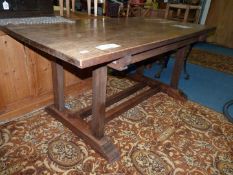 A bespoke Oak Refectory Dining Table having a four plank top and standing on rectangular legs with