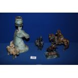 Four small oriental figures of horses with riders and a horse head metal candle holder