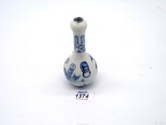 A Chinese blue and white china bottle vase, 5 1/4" tall, (small chip to rim).