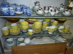 A quantity of Balinese dinner and Teaware with wild animals painted on a vivid yellow ground and