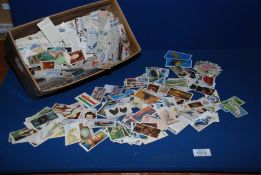 A shoe box of cigarette Cards containing 100's of old cards.
