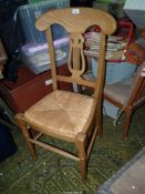 A contemporary lightwood framed lyre backed sea-grass seated Side Chair having turned front legs.