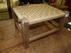 A small Stool having a woven string seat, 14'' x 11'' x 8 3/4'' high.