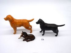 A Beswick black Labrador and golden Labrador together with a Royal Doulton foal.