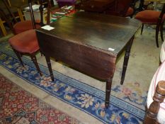 A late Victorian Mahogany Pembroke Table with tapering turned legs and a drawer having a cobalt