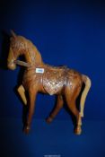 A carved wooden horse 20'' high x 16 1/2'' long