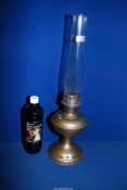 A Victorian brass Aladdin oil lamp with glass chimney and bottle of lamp oil, 23 1/2" tall.